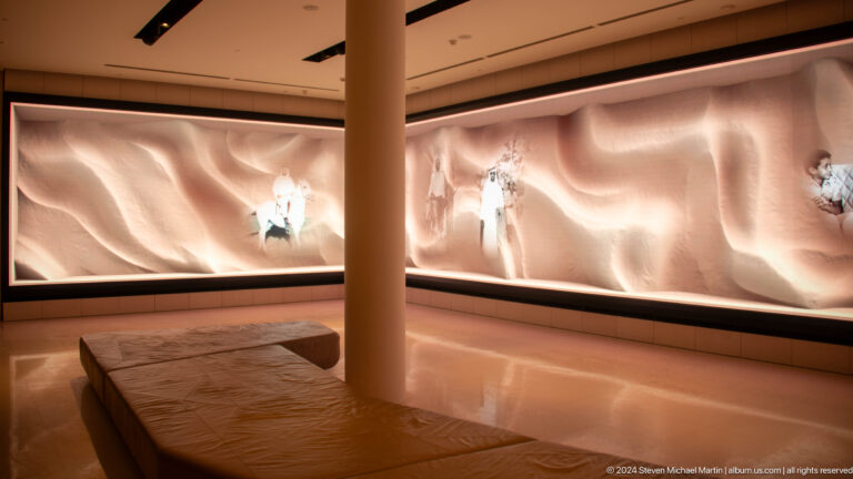 Curved panoramic digital projection inside The Founder's Memorial in Abu Dhabi, with a continuous illuminated screen wrapping around the gallery and a central column interrupting the image.