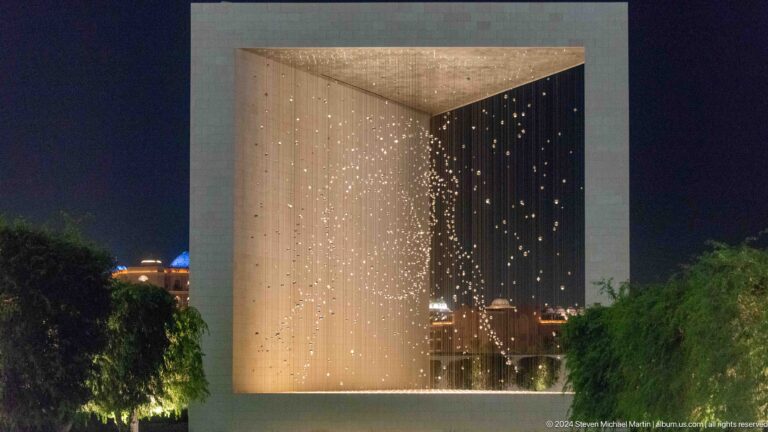 Night view of The Constellation at The Founder's Memorial in Abu Dhabi, showing dense points of warm light suspended inside a cubic frame and forming a portrait of Sheikh Zayed from certain angles.