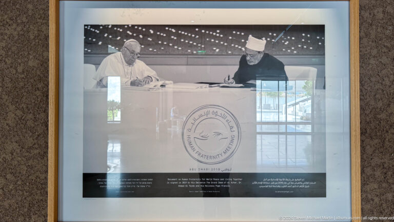 Archival document with a large circular seal displayed behind glass at The Founder's Memorial in Abu Dhabi.