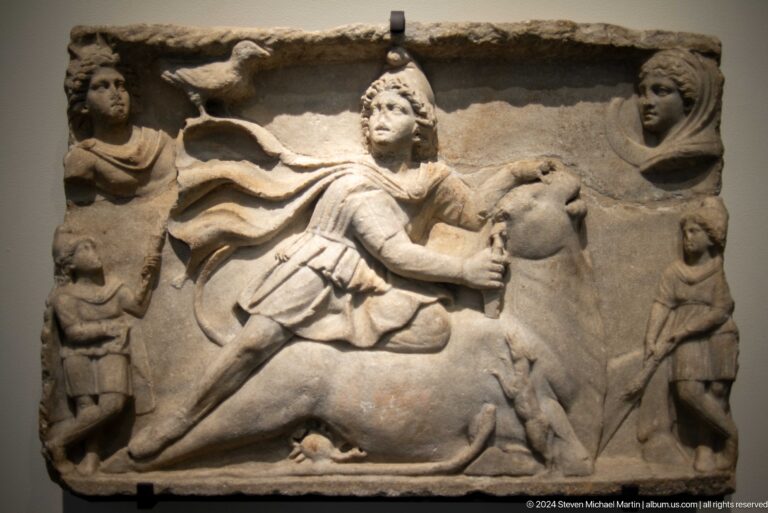 Stone relief of mounted rider in combat at Louvre Abu Dhabi.