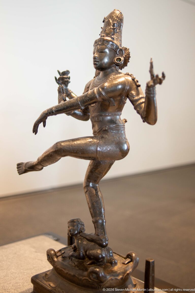 Bronze running or leaping male figure at Louvre Abu Dhabi.