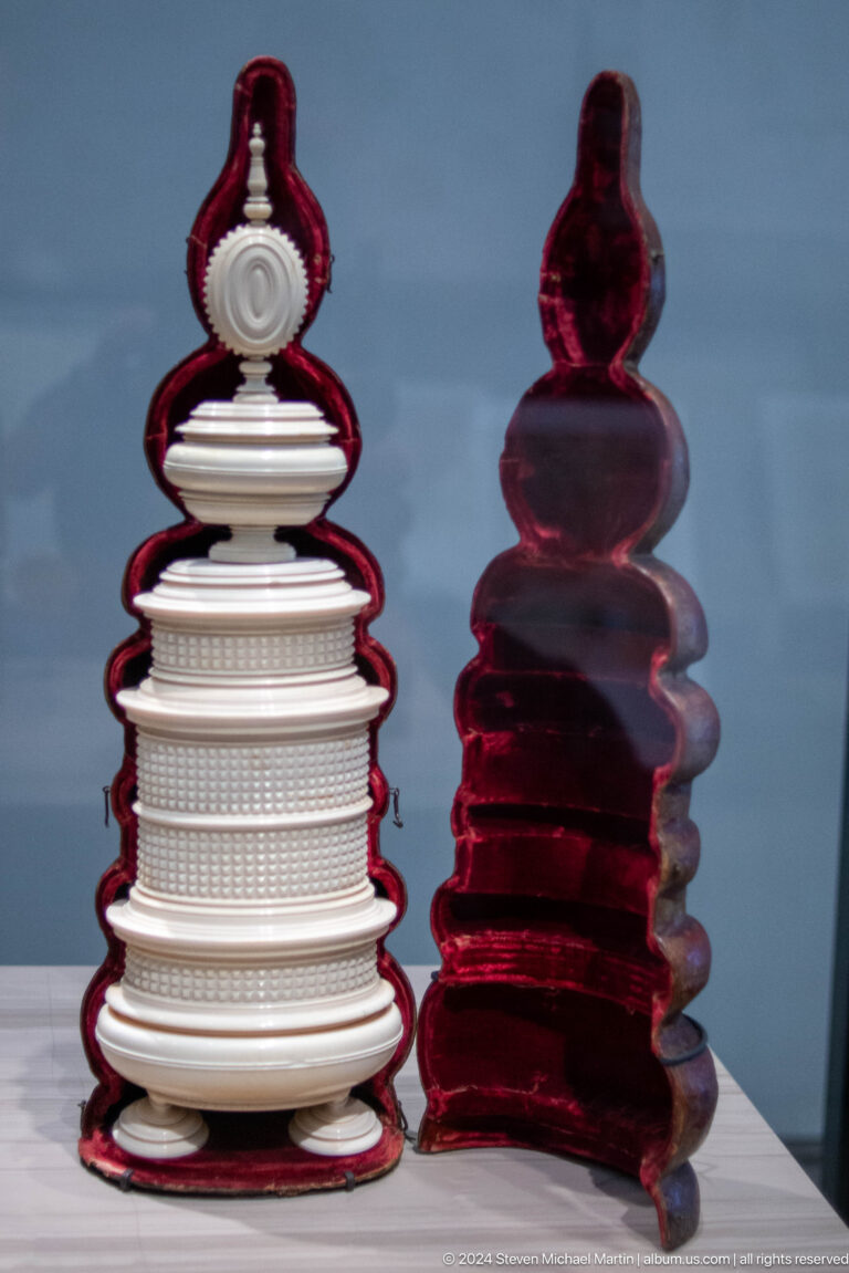 Paired red and white stacked glass forms at Louvre Abu Dhabi.
