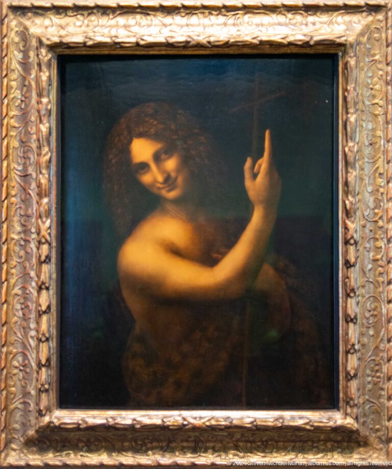 Framed painting of a figure raising one hand at Louvre Abu Dhabi.