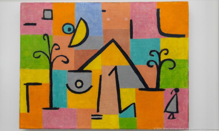 Colorful abstract painting of geometric faces at Louvre Abu Dhabi.