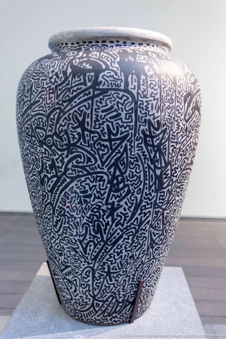 Close view of black-and-white calligraphic ceramic surface at Louvre Abu Dhabi.