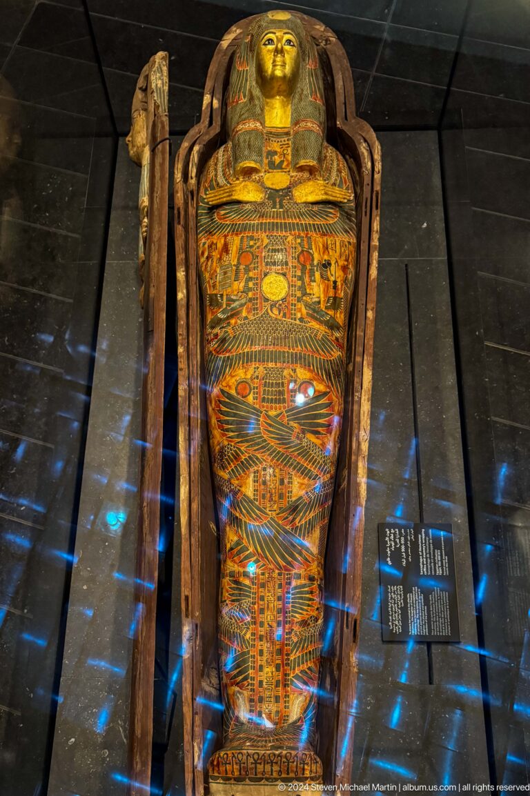 Close detail of painted coffin decoration at Louvre Abu Dhabi.