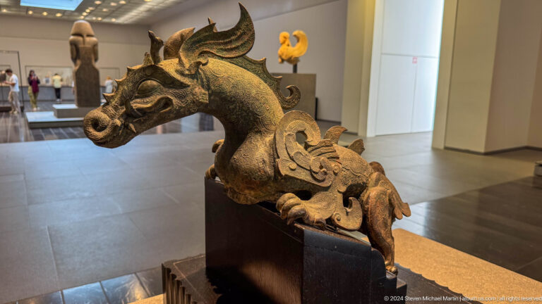 Carved dragon or mythical beast sculpture at Louvre Abu Dhabi.