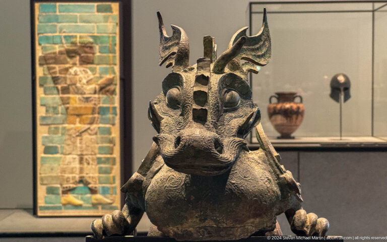 Horned mythical animal sculpture in gallery at Louvre Abu Dhabi.