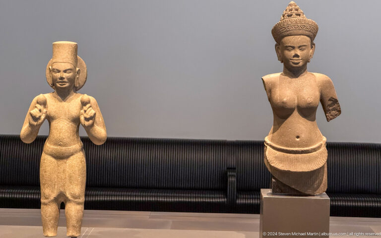 Two small standing female figures at Louvre Abu Dhabi.