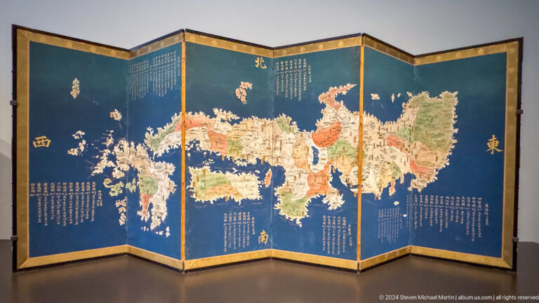 Folding screen painted with map of europe and asia at Louvre Abu Dhabi.