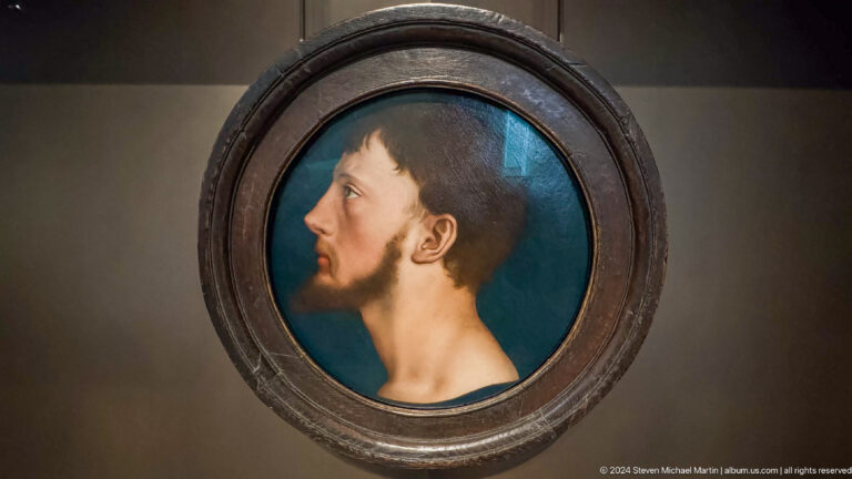 Round portrait medallion of bearded man in profile at Louvre Abu Dhabi.
