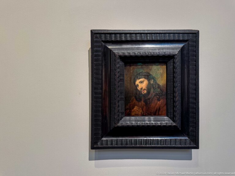 Small framed portrait in elaborate black frame at Louvre Abu Dhabi.