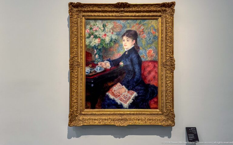 Framed portrait of seated woman beside flowers at Louvre Abu Dhabi.
