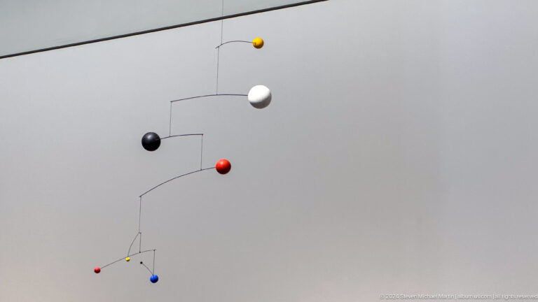 Delicate hanging mobile with colored spheres at Louvre Abu Dhabi.
