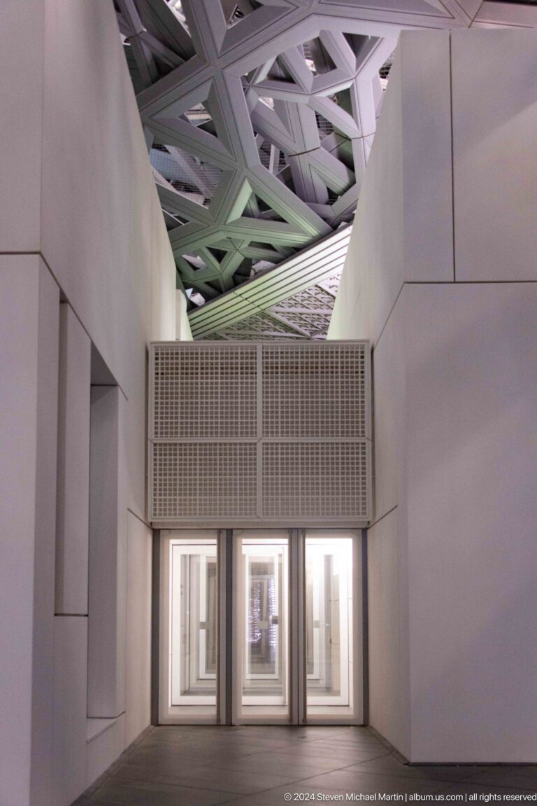 Stacked lattice ventilation structure between galleries at Louvre Abu Dhabi.