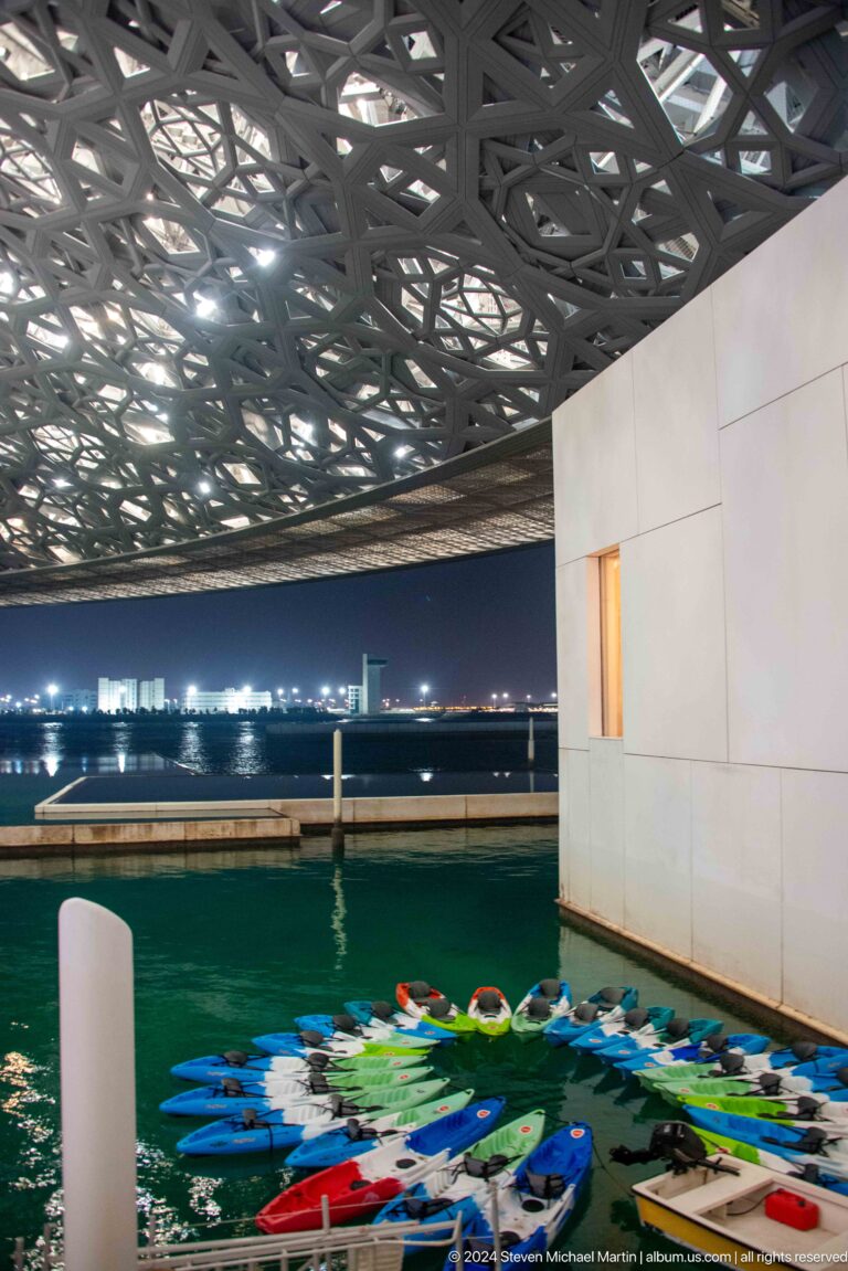 Waterfront opening toward abu dhabi skyline at Louvre Abu Dhabi.