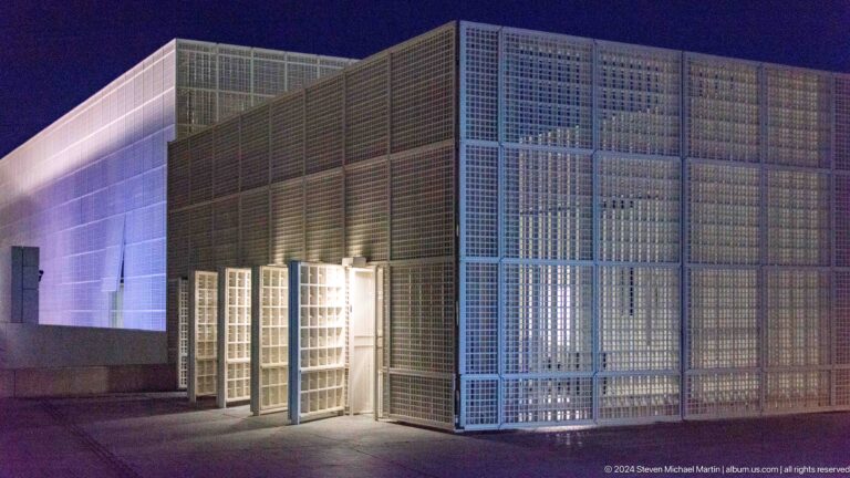 Glowing lattice-clad pavilion at night at Louvre Abu Dhabi.
