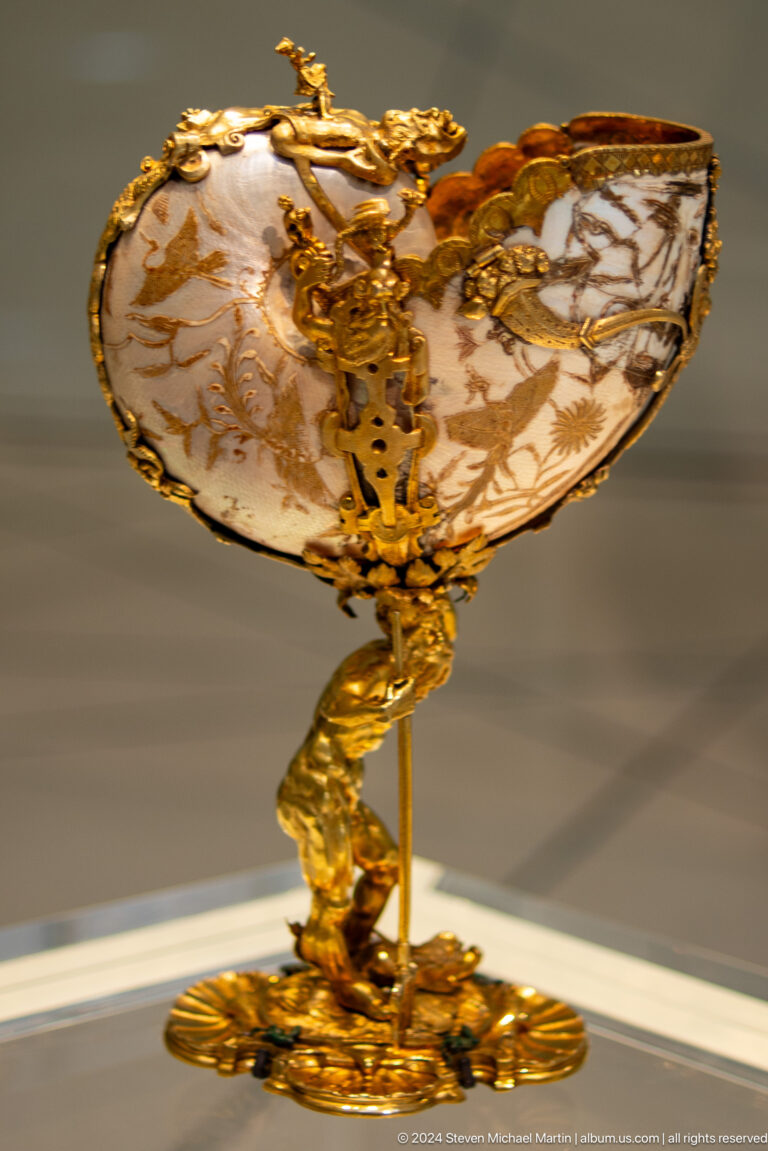 Gilded animal-shaped support beneath vessel at Louvre Abu Dhabi.