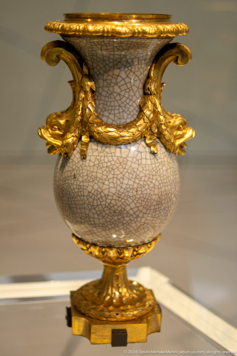 Crackle-glazed vessel with gilded animal mounts at Louvre Abu Dhabi.