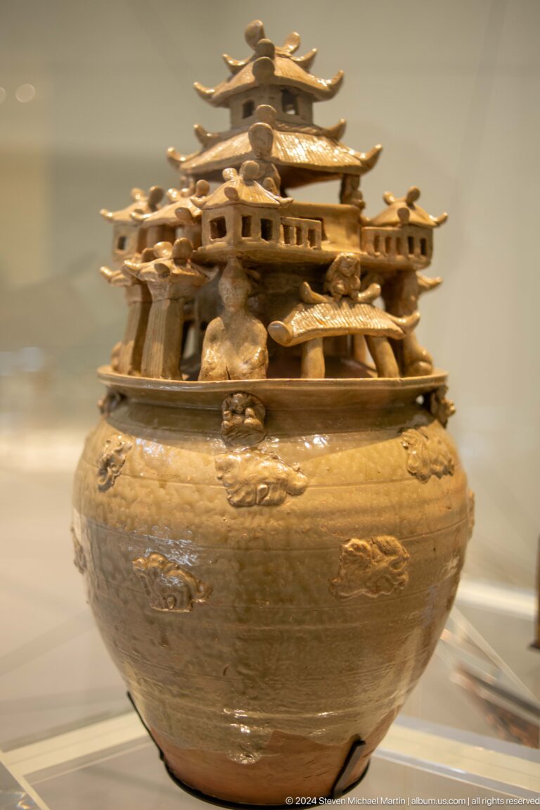 Ancient ceramic vessel with miniature animal frieze at Louvre Abu Dhabi.