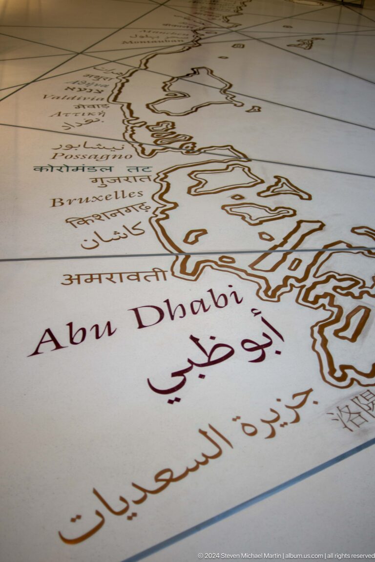 Map graphic labeled abu dhabi in several scripts at Louvre Abu Dhabi.