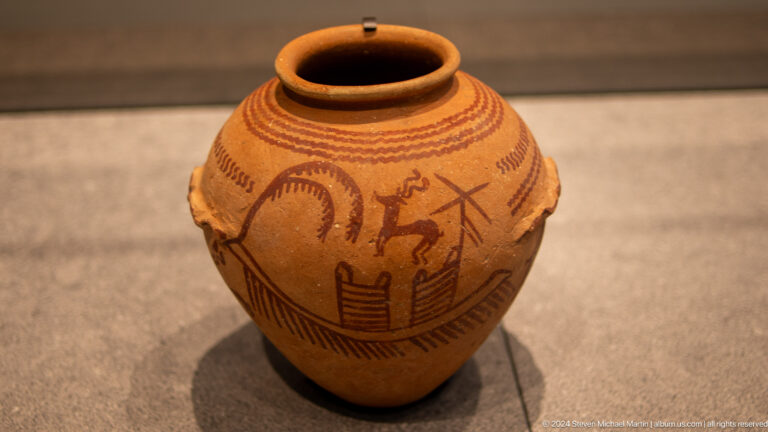 Painted ceramic jar with animal motifs at Louvre Abu Dhabi.