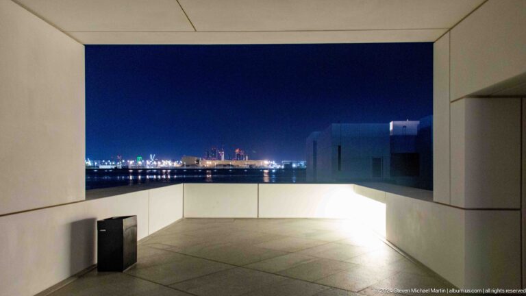 Open terrace framing distant city lights at Louvre Abu Dhabi.