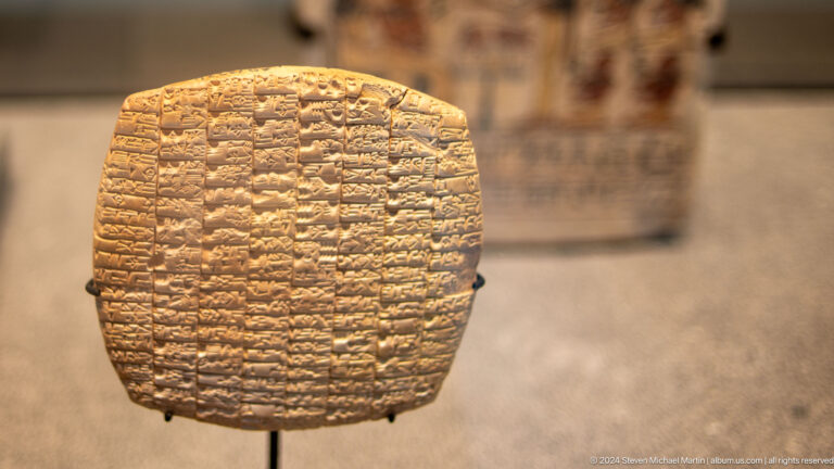 Clay tablet densely covered with cuneiform at Louvre Abu Dhabi.