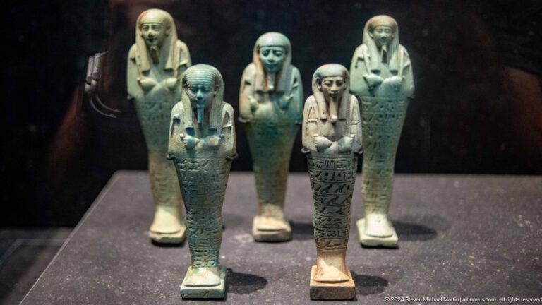 Group of blue-green funerary figurines at Louvre Abu Dhabi.