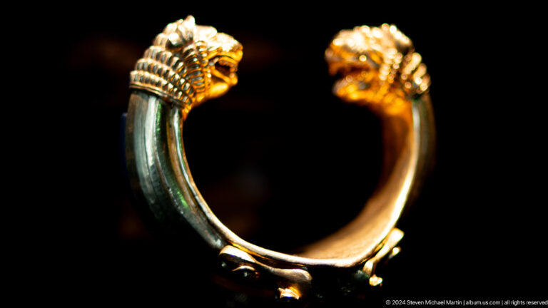 Gold and green animal-headed bracelet at Louvre Abu Dhabi.