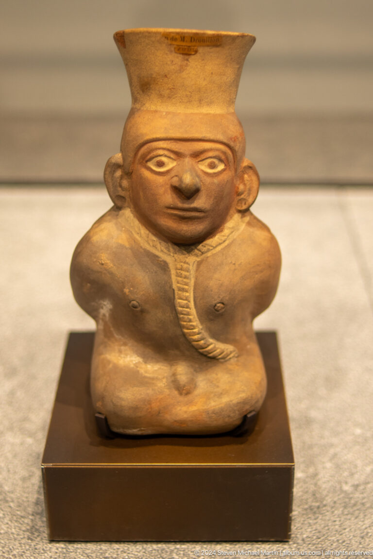 Round-bodied clay figure with necklace at Louvre Abu Dhabi.
