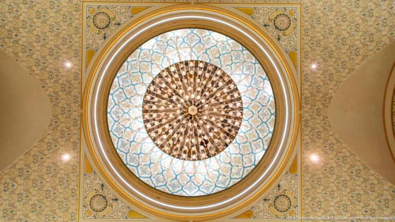 Circular stained-glass and geometric ceiling medallion.