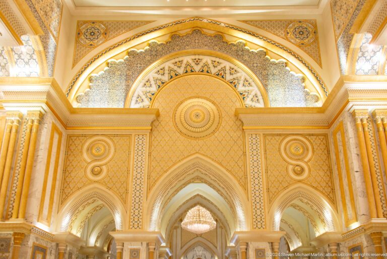 Gold and cream vaulted interior with arched openings.
