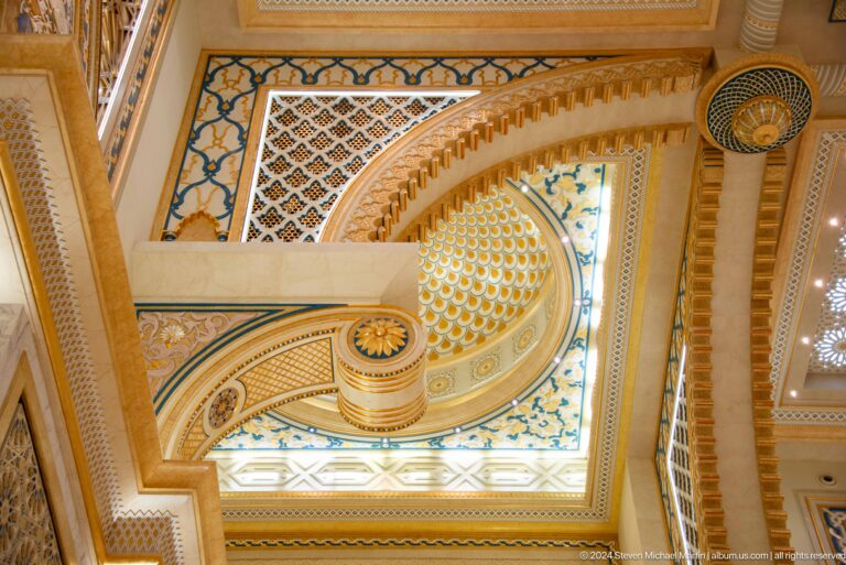 Decorative ceiling with sweeping geometric bands.