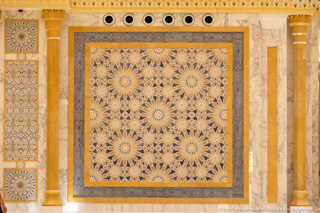 Rectangular geometric wall panel in gold and cream.