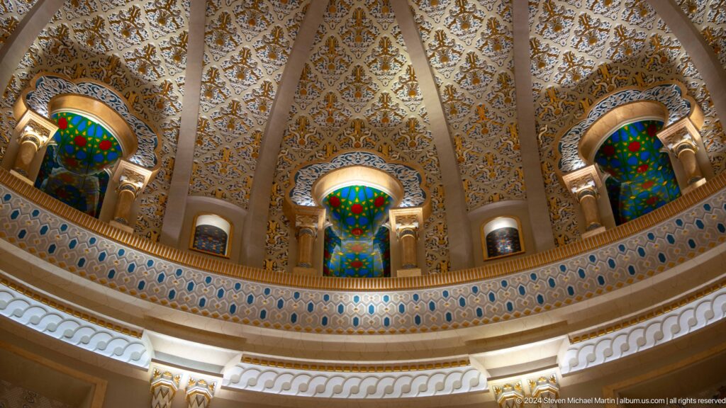 Upper dome interior with stained-glass windows.