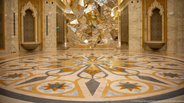 Marble floor with large geometric floral design.