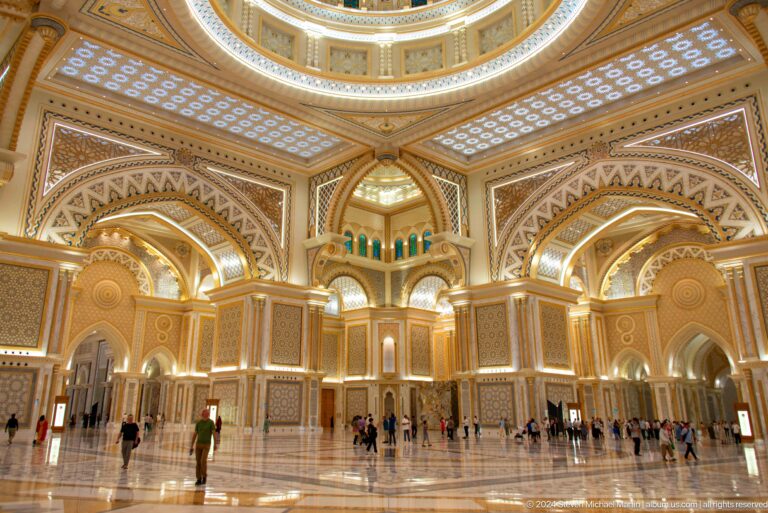 Wide great hall with visitors beneath vaulted arches.