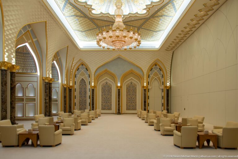 Formal meeting room with cream seating and chandelier.