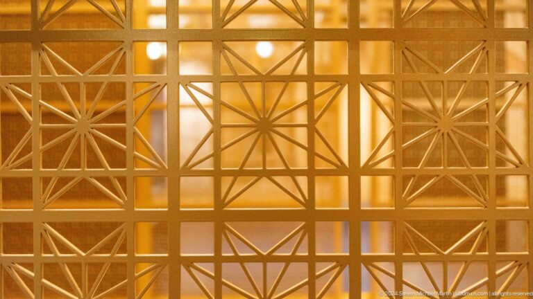 Gold geometric lattice panel.