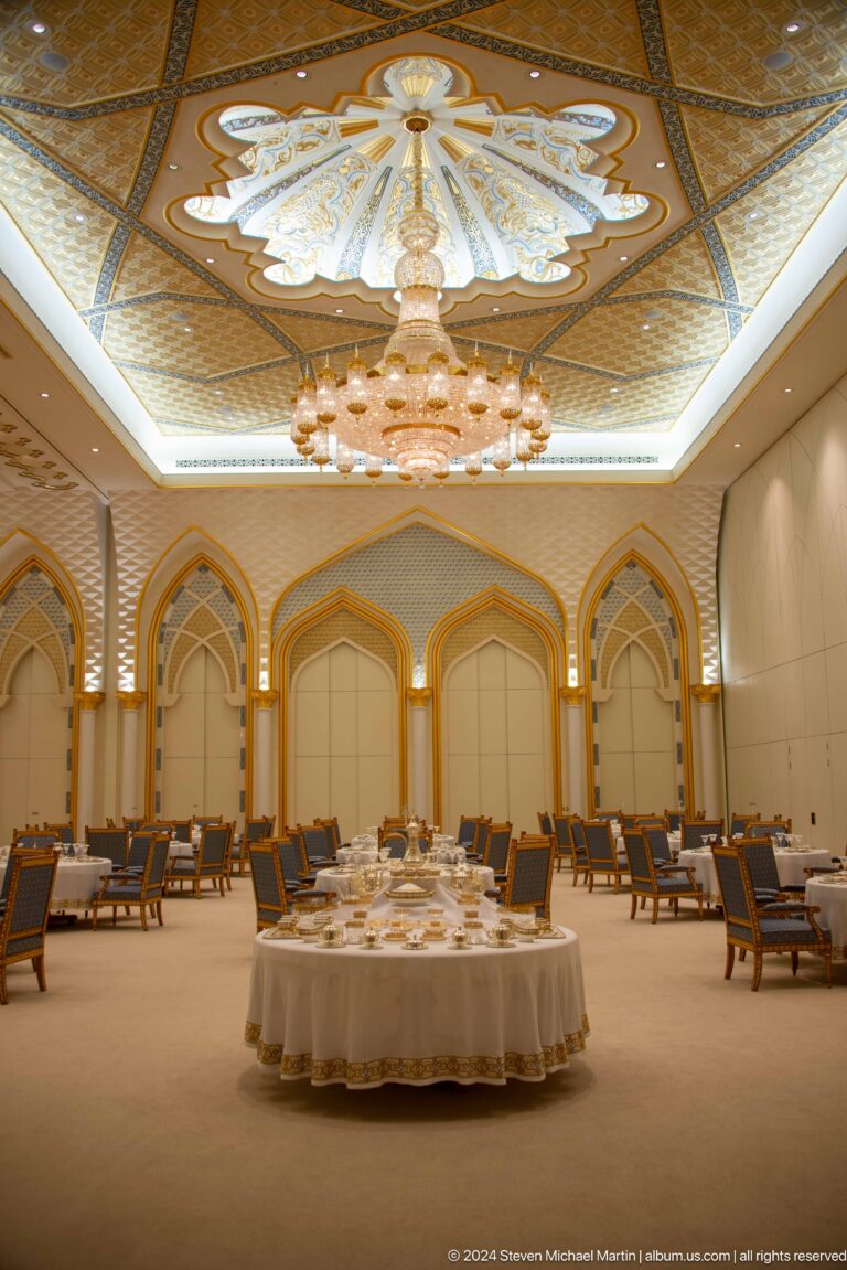 Formal banquet or meeting room with rows of chairs.