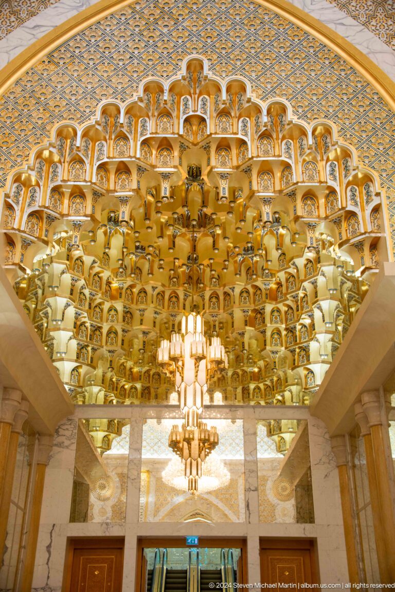 Large tiered chandelier with many gold elements.