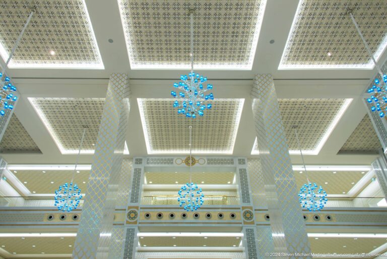 White ceiling grid with blue hanging ornaments.