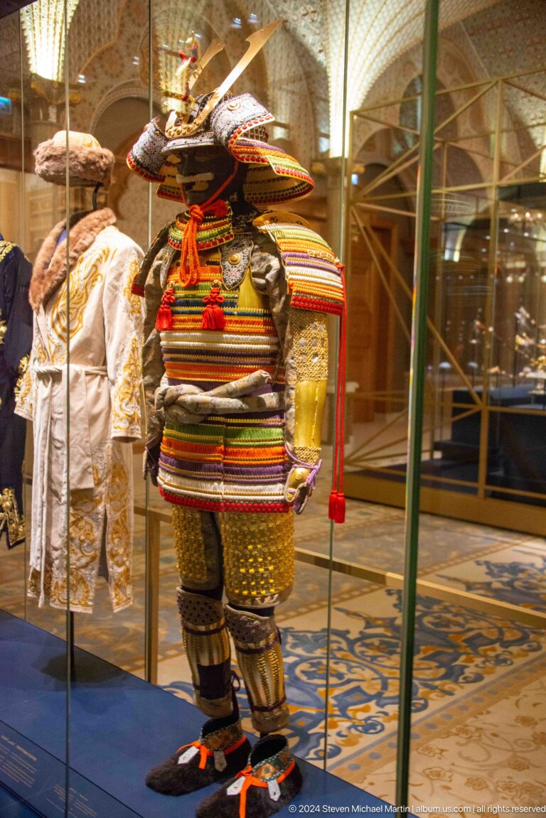 Striped traditional garment displayed in glass case.
