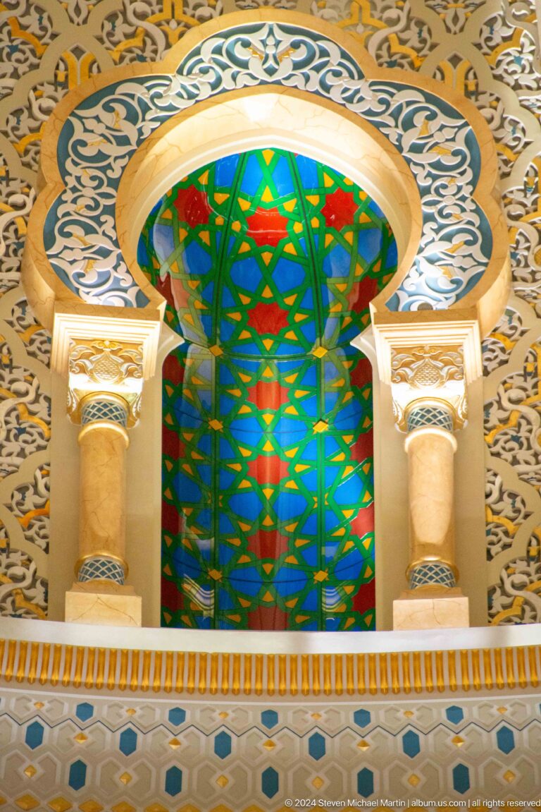 Stained-glass arch in blue green and red.