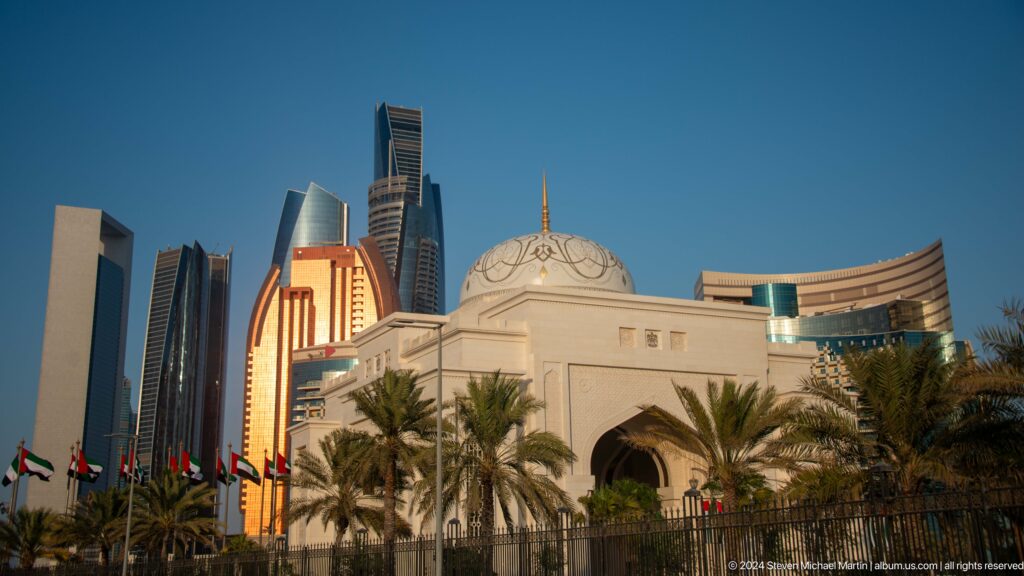 White domed palace pavilion with modern towers behind.