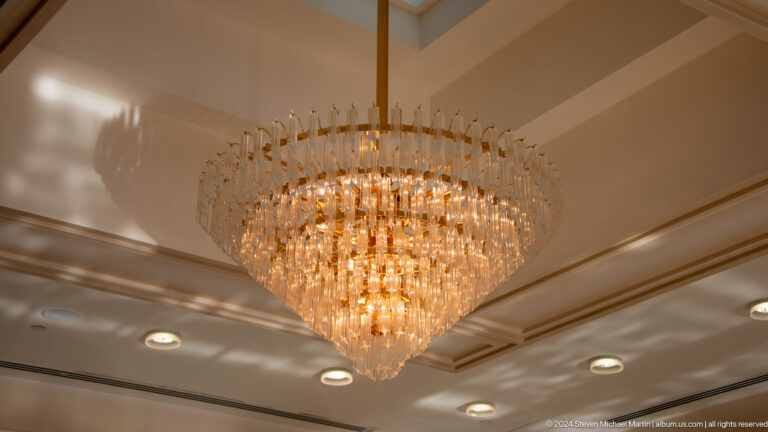 Large tiered crystal chandelier in reception room.