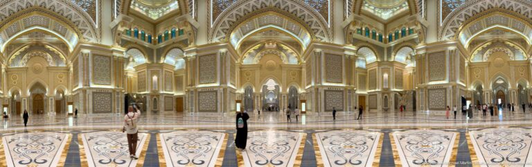 Visitor standing alone in center of great hall.