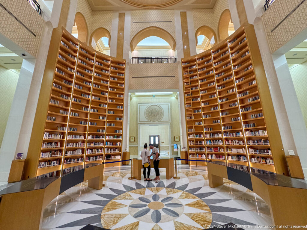 Tall library room with bookshelves on both sides.