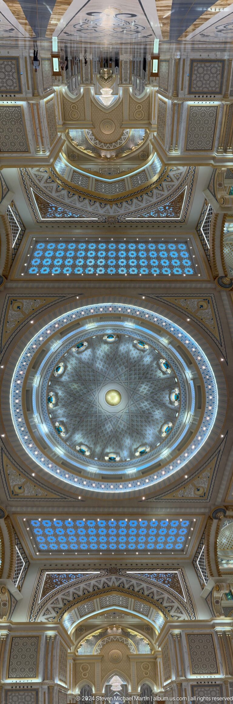 Circular blue-lit ceiling dome viewed upward.